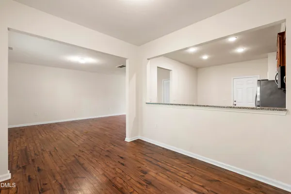 a view of a kitchen with wooden floor