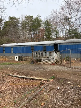 a view of a yard with wooden fence