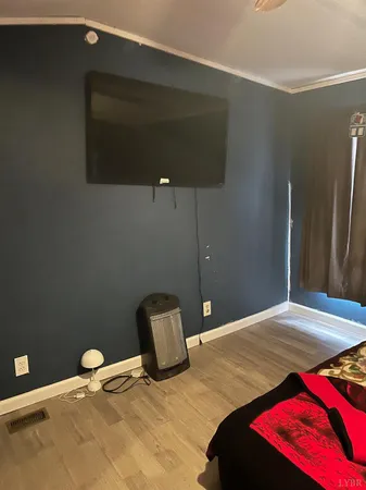 a bedroom with a bed and a potted plant