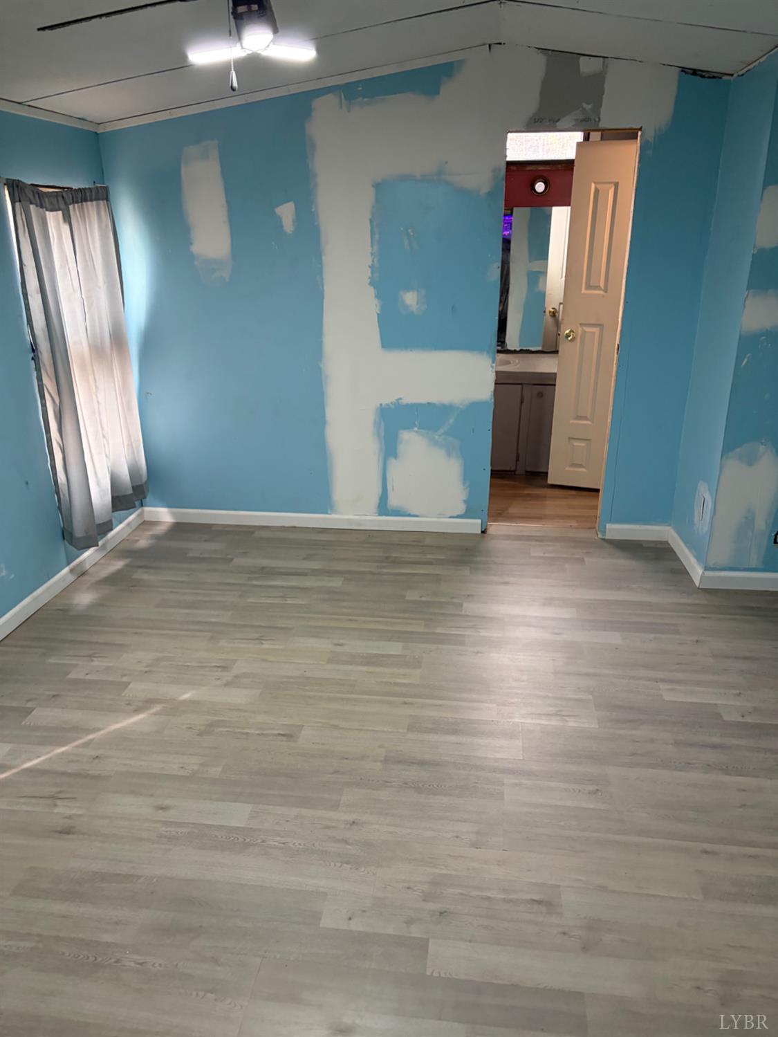 65 June Way Evington, VA 24550 - Photo 4 of 13 a view of an empty room with wooden floor and a window