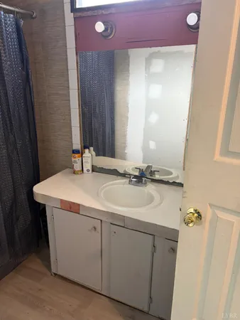 a bathroom with a sink vanity and a mirror