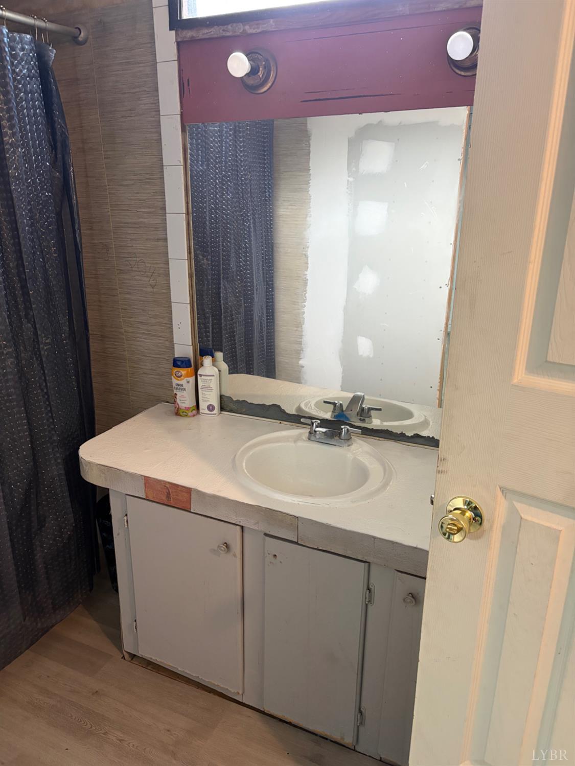 65 June Way Evington, VA 24550 - Photo 7 of 13 a bathroom with a sink vanity and a mirror