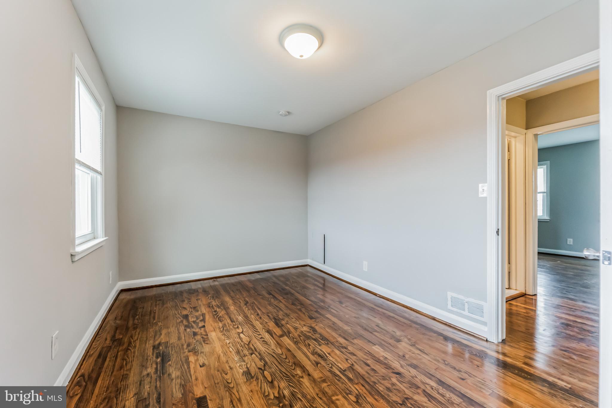 3422 Dunran Road Dundalk, MD 21222 - Photo 19 of 30 wooden floor in an empty room with a window