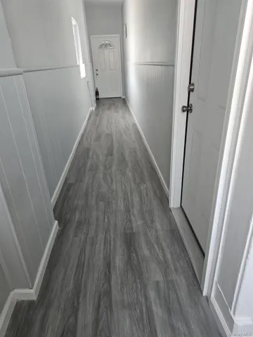 a view of a hallway view with wooden floor
