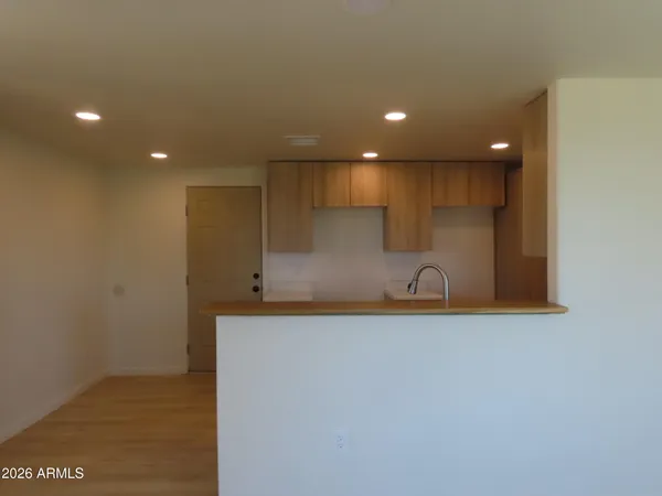 a kitchen with kitchen island a sink appliances and cabinets