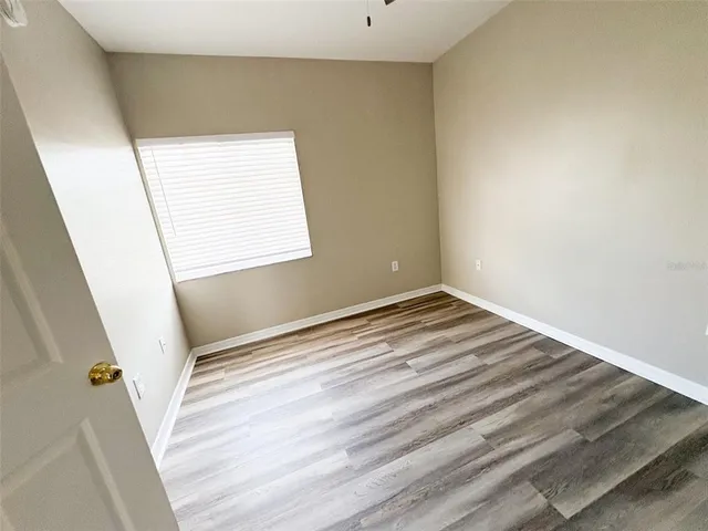 a view of a livingroom with wooden floor and staircase