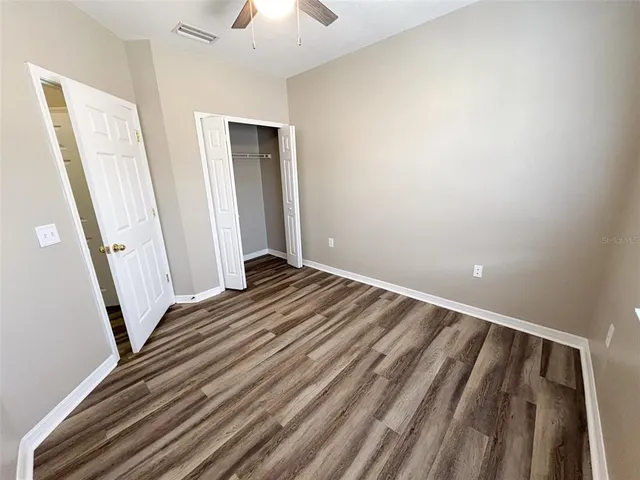 a view of a room with wooden floor and staircase