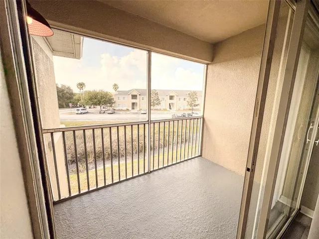 a view of an empty room and wooden floor