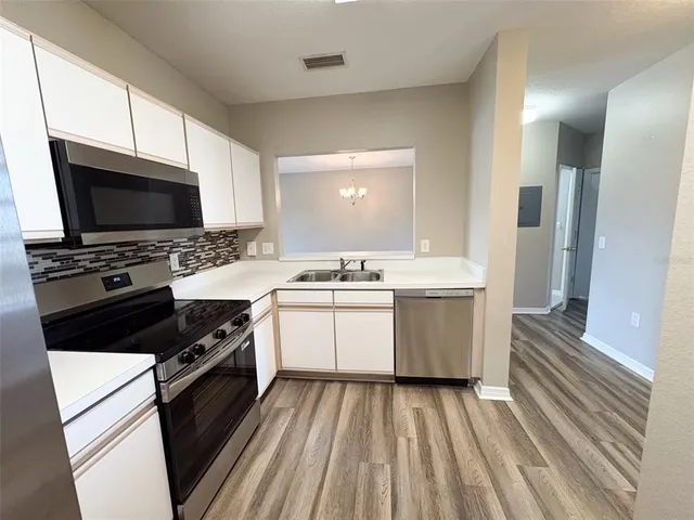 a bathroom with a sink a large mirror and a bathtub