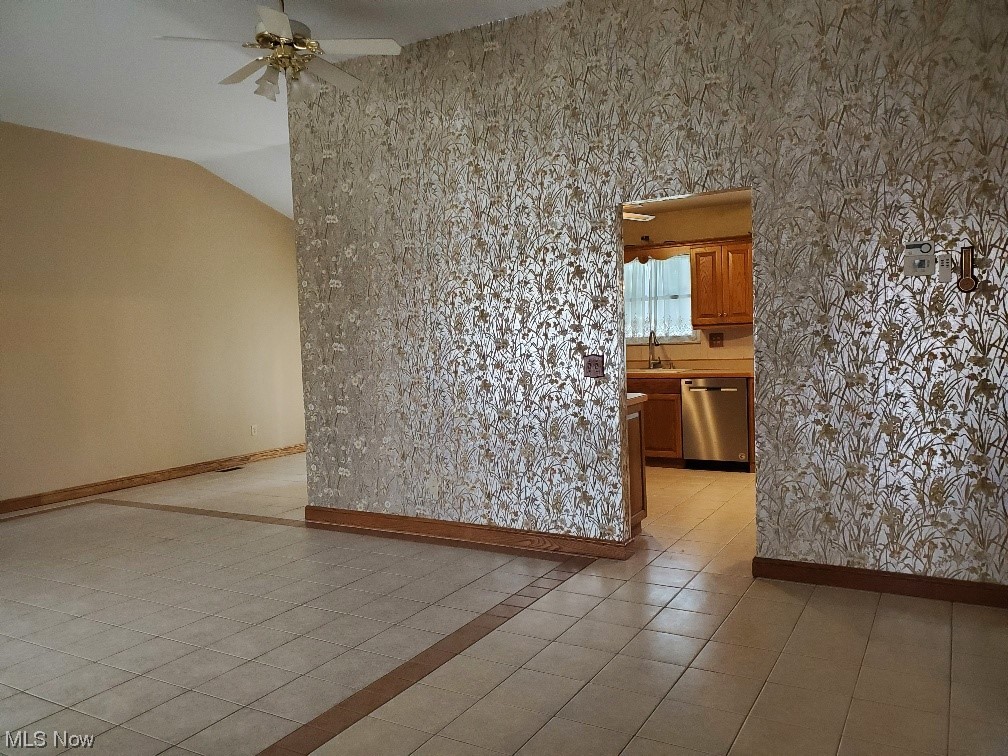 12221 Reno Drive Parma, OH 44130 - Photo 7 of 29 Tiled empty room with ceiling fan and lofted ceiling