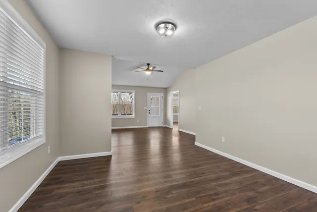 wooden floor in an empty room with a window