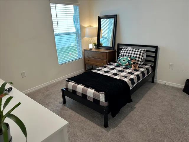 a bedroom with a bed and window