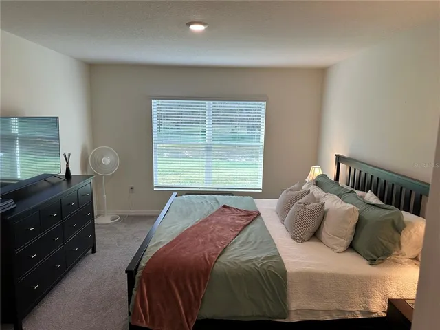 a bedroom with a bed and window