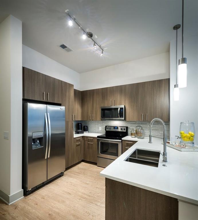 400 Pharr Road Northeast, Unit 231 Atlanta, GA 30305 - Photo 2 of 23 a kitchen with stainless steel appliances a refrigerator sink and microwave
