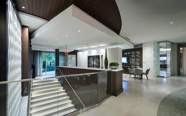 a living room with furniture a rug and painting on wall