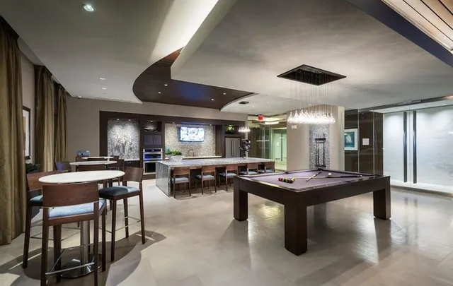 a living room with lots of furniture and a large window