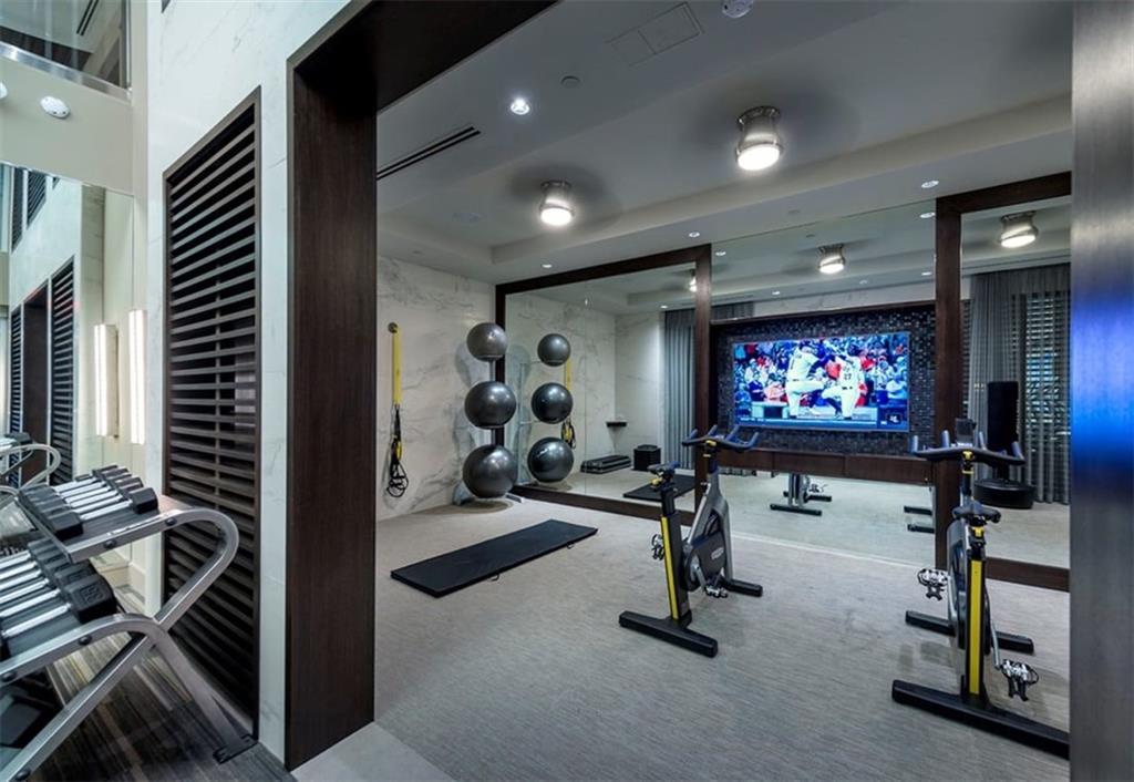 400 Pharr Road Northeast, Unit 231 Atlanta, GA 30305 - Photo 23 of 23 a room with gym equipment and a flat screen tv