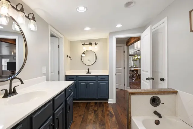 a bathroom with a sink a mirror and a toilet