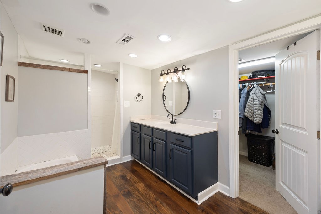 1200 Wray Branch Road Minor Hill, TN 38473 - Photo 15 of 29 a bathroom with a double vanity sink mirror and shower