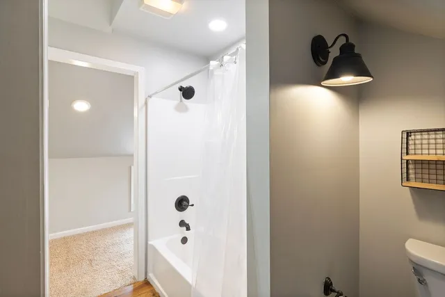 a bathroom with a bathtub and a shower