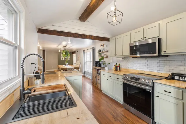 a kitchen with a stove a sink and a microwave