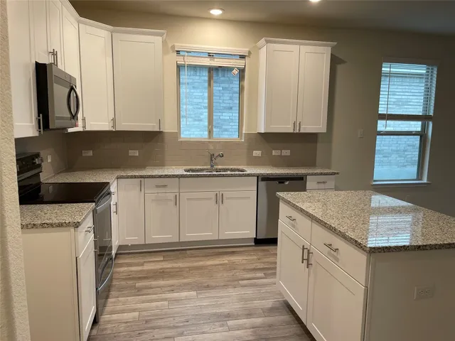 a kitchen with a sink stove and refrigerator