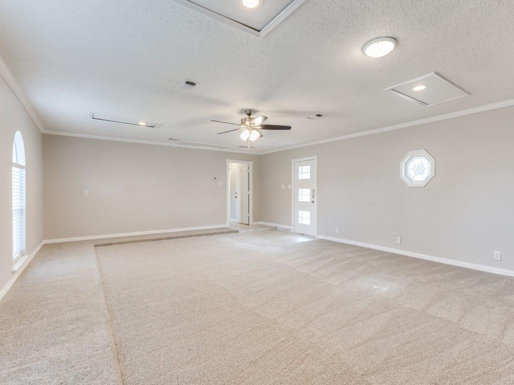 7325 Reed Road Azle, TX 76020 - Photo 15 of 38 Empty room featuring light carpet, a ceiling fan, a textured ceiling, crown molding, and recessed lighting