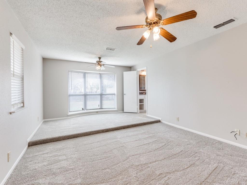 7325 Reed Road Azle, TX 76020 - Photo 22 of 38 Carpeted spare room featuring a textured ceiling and ceiling fan