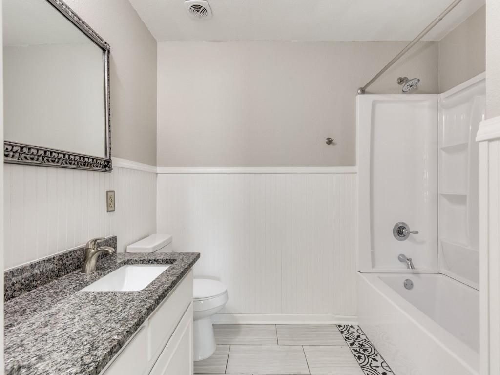 7325 Reed Road Azle, TX 76020 - Photo 27 of 38 Full bath with bathtub / shower combination, wainscoting, vanity, and light tile patterned flooring