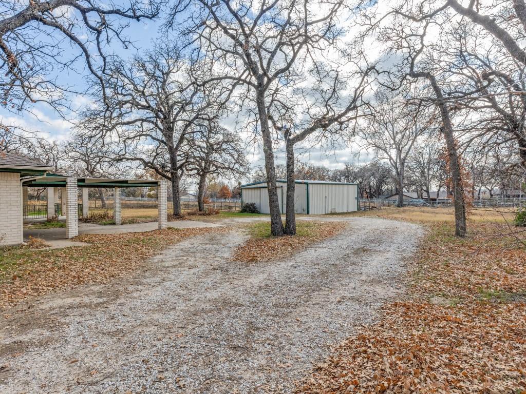 7325 Reed Road Azle, TX 76020 - Photo 5 of 38 View of dirt / gravel road featuring an outbuilding