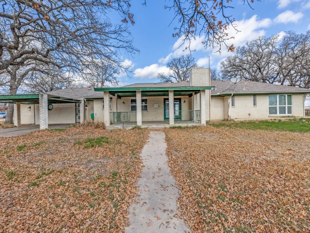 7325 Reed Road Azle, TX 76020 - Photo 8 of 38 Ranch-style home featuring covered porch, brick siding, a chimney, and a carport