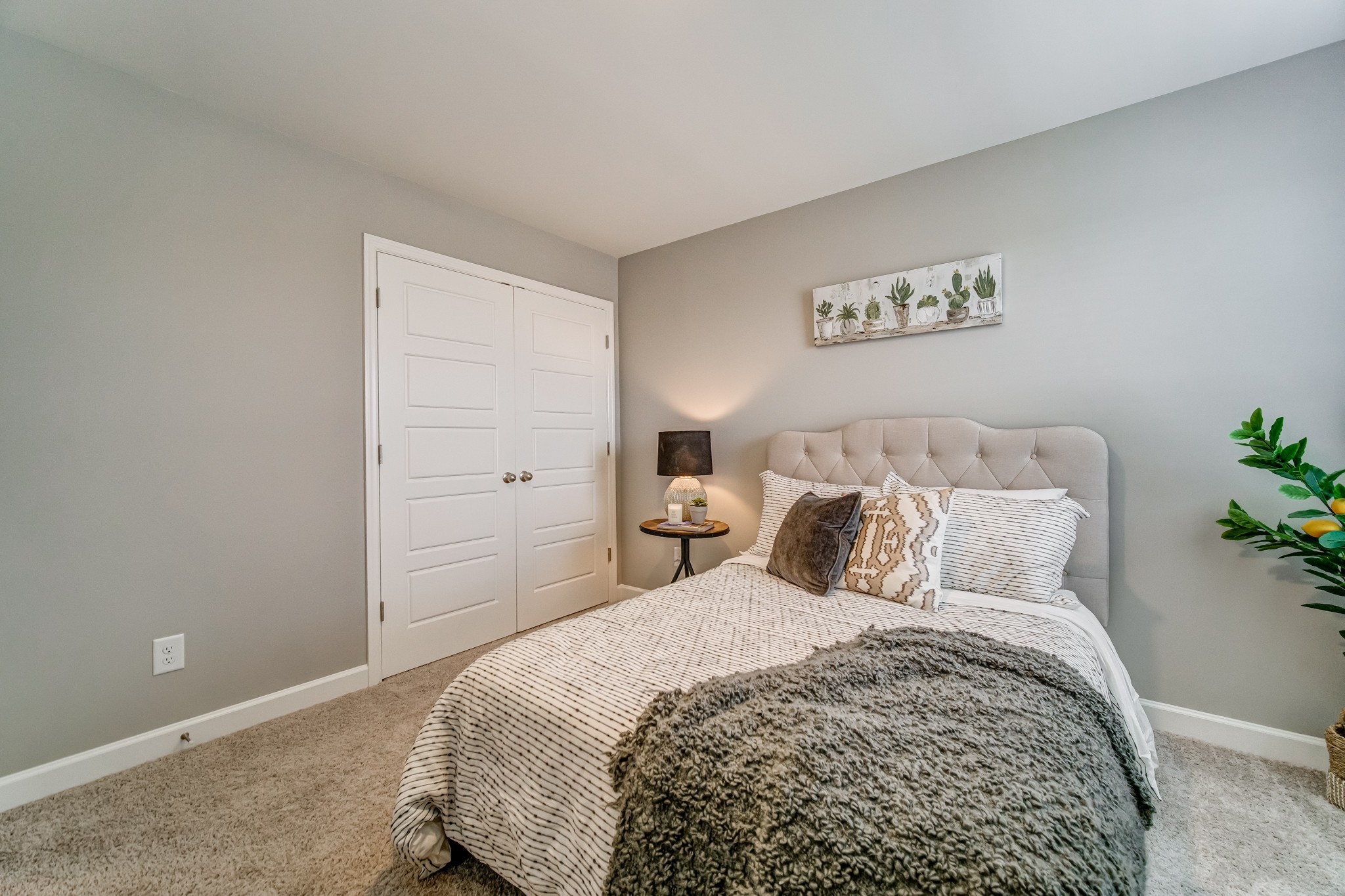 446 Withrow Way Gallatin, TN 37066 - Photo 22 of 25 a bedroom with a large bed and a potted plant