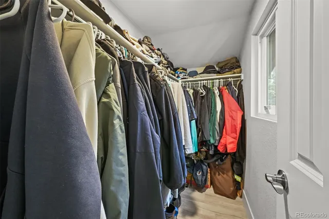 a view of walk in closet with clothes