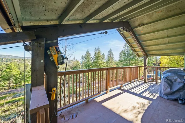 a balcony with chairs and wooden floor