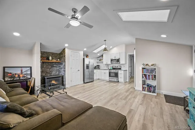 a living room with furniture and kitchen view
