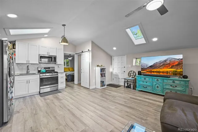 a kitchen with stainless steel appliances kitchen island granite countertop a stove a refrigerator and a microwave