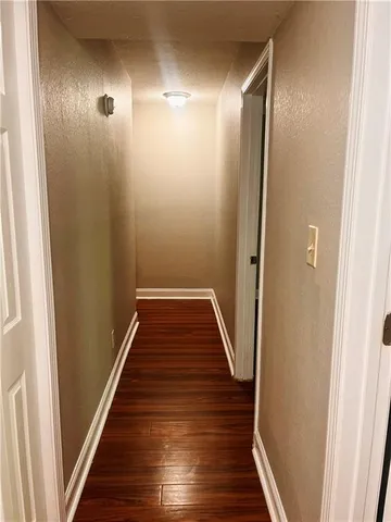 a view of a hallway with wooden floor