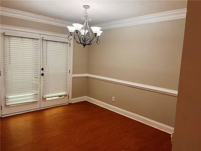 an empty room with wooden floor