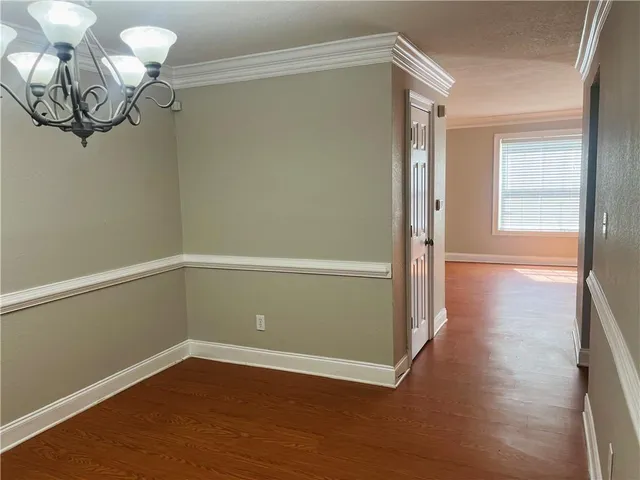 a view of a room with wooden floor and fan