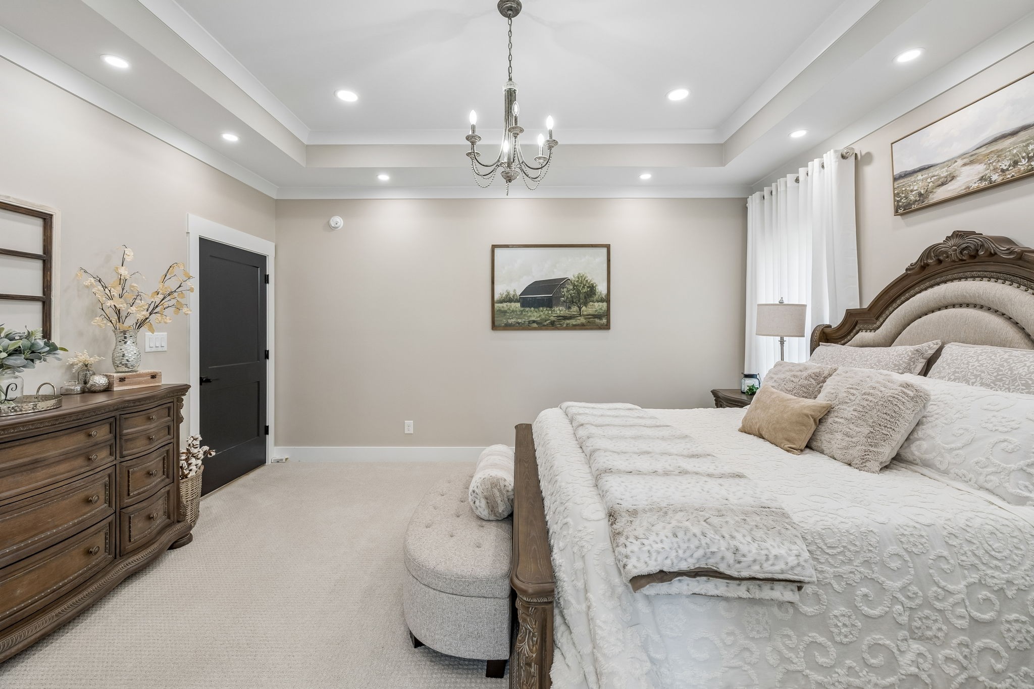 59 Huddleston Road Lascassas, TN 37085 - Photo 23 of 60 a bedroom with a large bed and a chandelier
