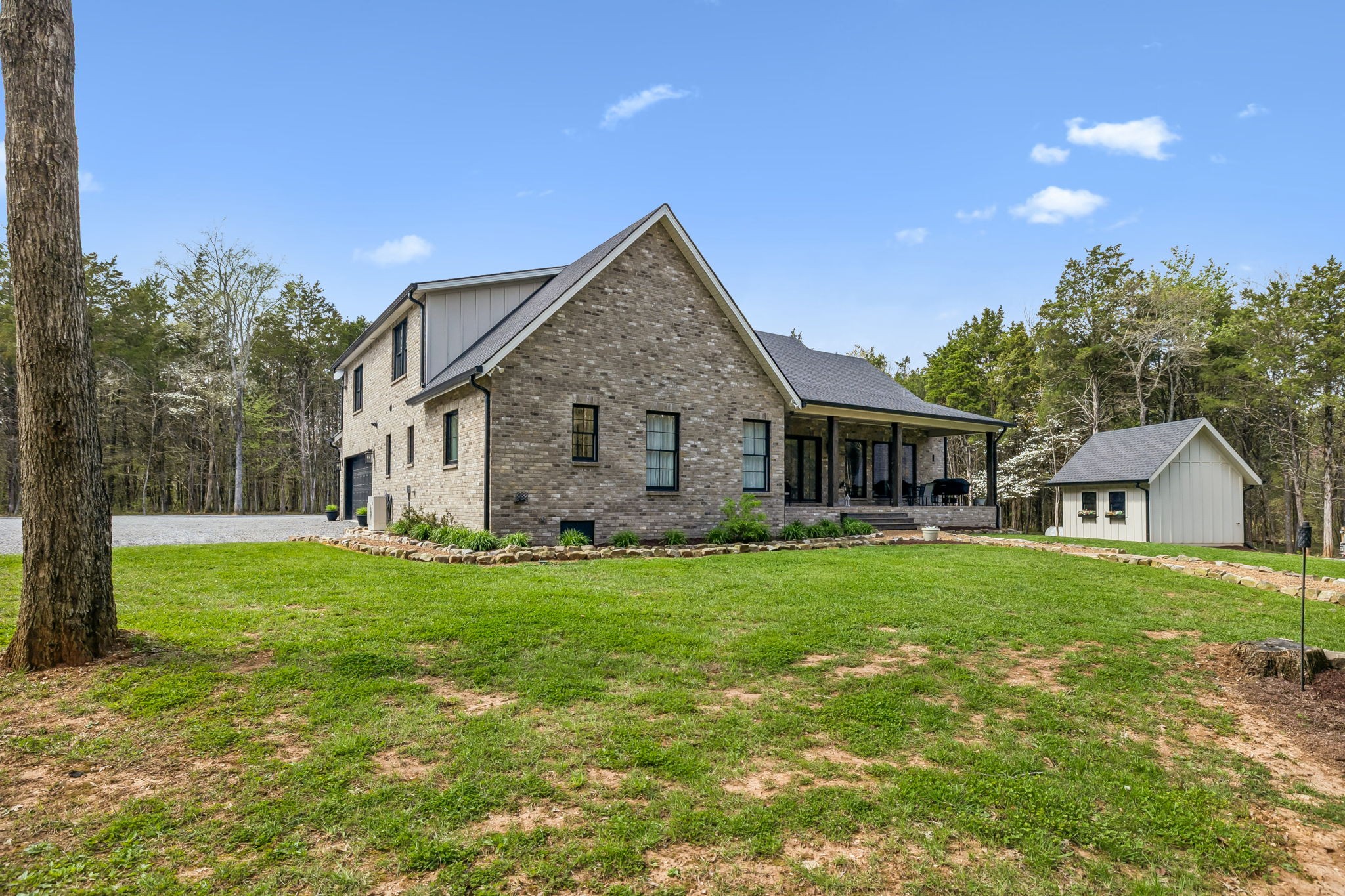 59 Huddleston Road Lascassas, TN 37085 - Photo 45 of 60 a front view of a house with a garden and trees