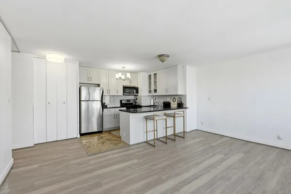 a kitchen with stainless steel appliances a refrigerator and a stove top oven