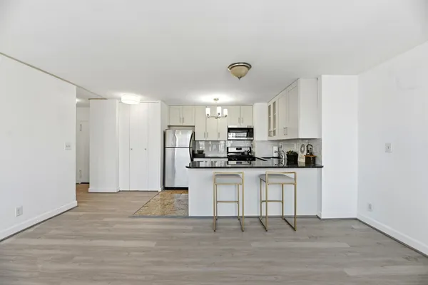 a kitchen with stainless steel appliances a refrigerator and a stove top oven