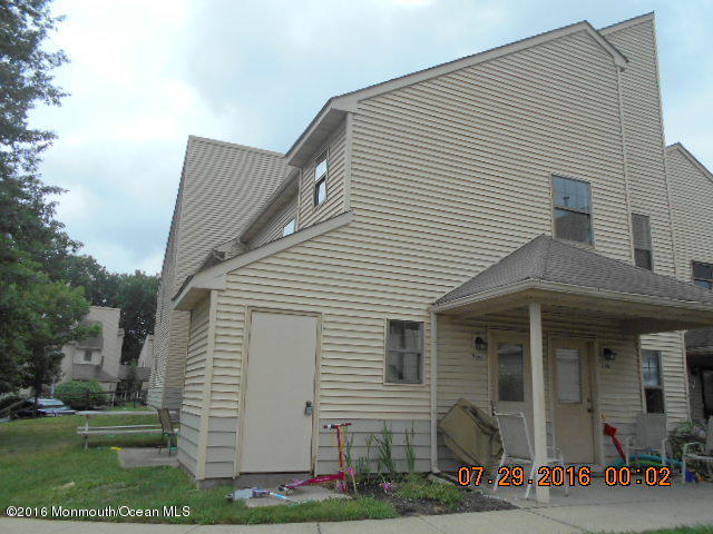 a view of a white house with many windows