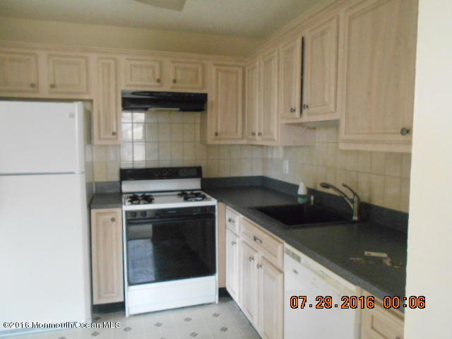 709 Ivy Court Jackson, NJ 08527 - Photo 4 of 8 a kitchen with granite countertop a sink a stove and cabinets