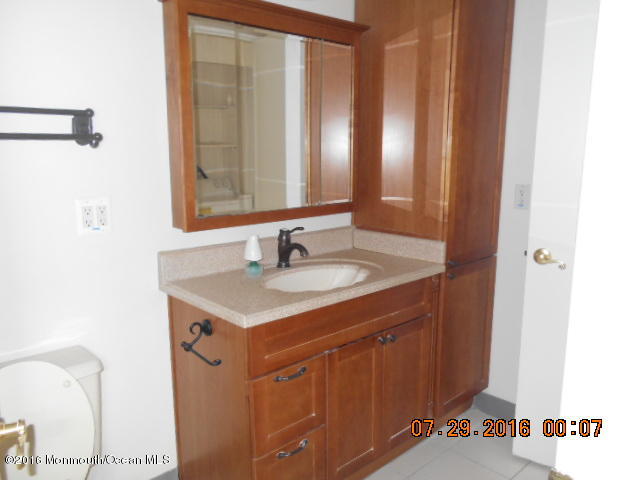 709 Ivy Court Jackson, NJ 08527 - Photo 6 of 8 a bathroom with a sink and a mirror