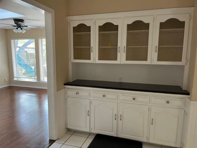 a kitchen with granite countertop a refrigerator and a stove top oven