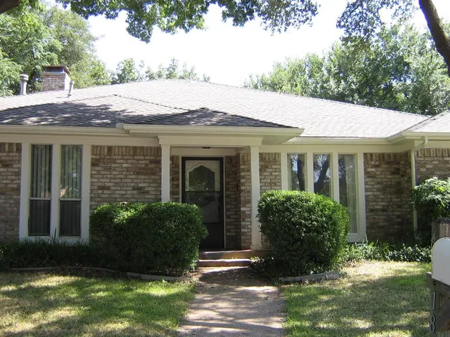 a view of a house with a yard and plants