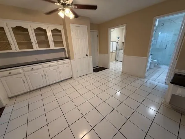 a kitchen with white cabinets appliances and a sink