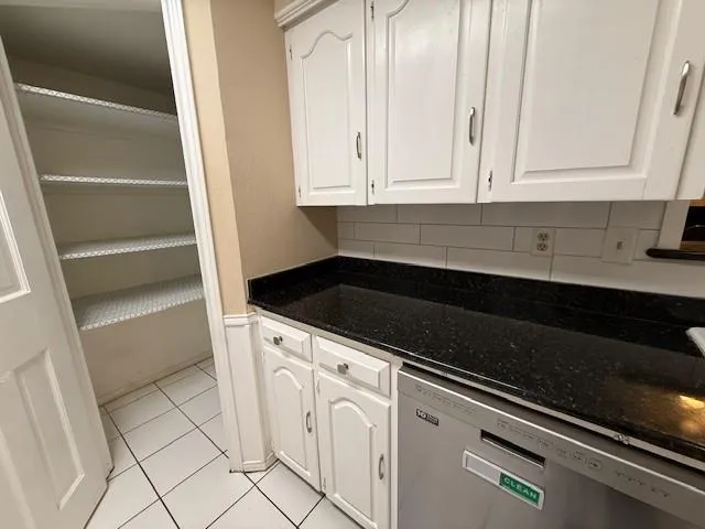 a view of an empty room with wooden floor fireplace and a window